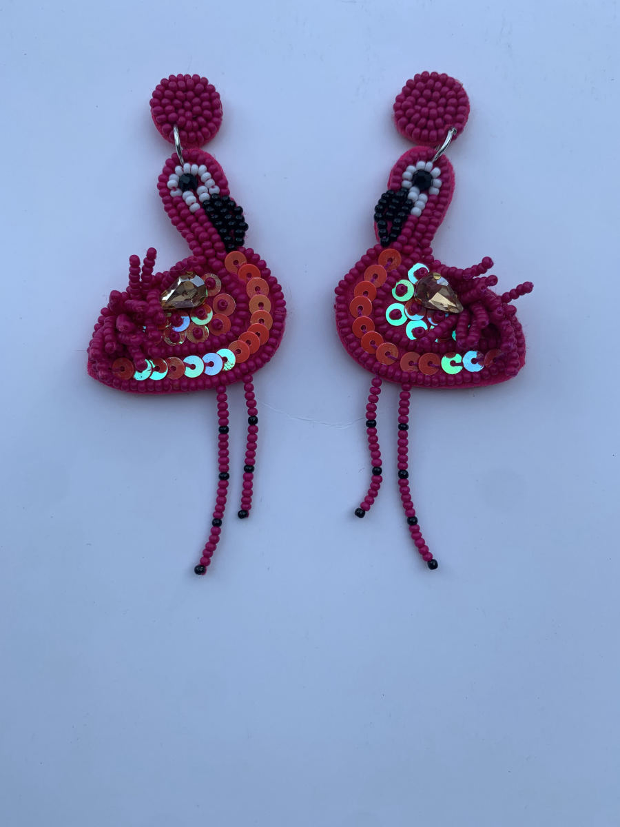 Beaded magenta flamingo earrings with sequin-covered iridescent wings, amber crystal body accent, dangling black bead legs, and round stud top.