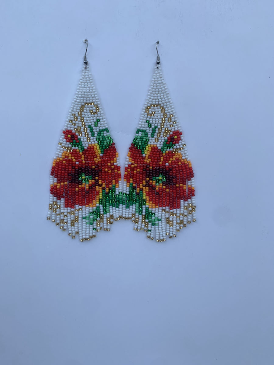 Long fringe earrings with large red flower on vine motif on white bead ground, scalloped fringe hem, wire hook.