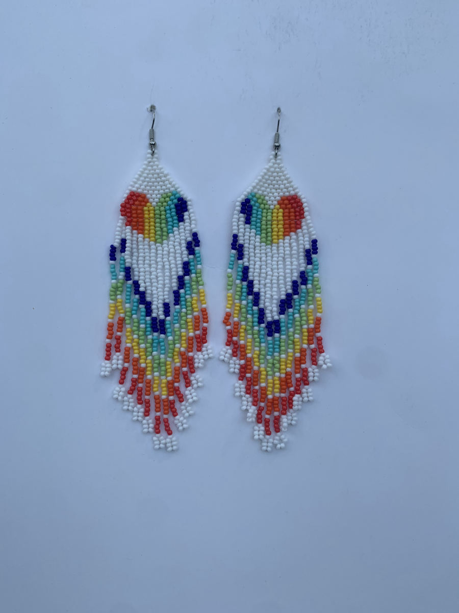 Long fringe earrings with rainbow heart motif on white bead ground, multicolour cascading fringe in orange, yellow, green, blue and red, wire hook.