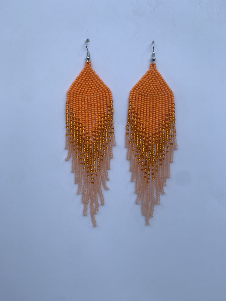Long fringe earrings in orange seed beads fading to pale peach with gold metallic accent beads woven throughout, wire hook.