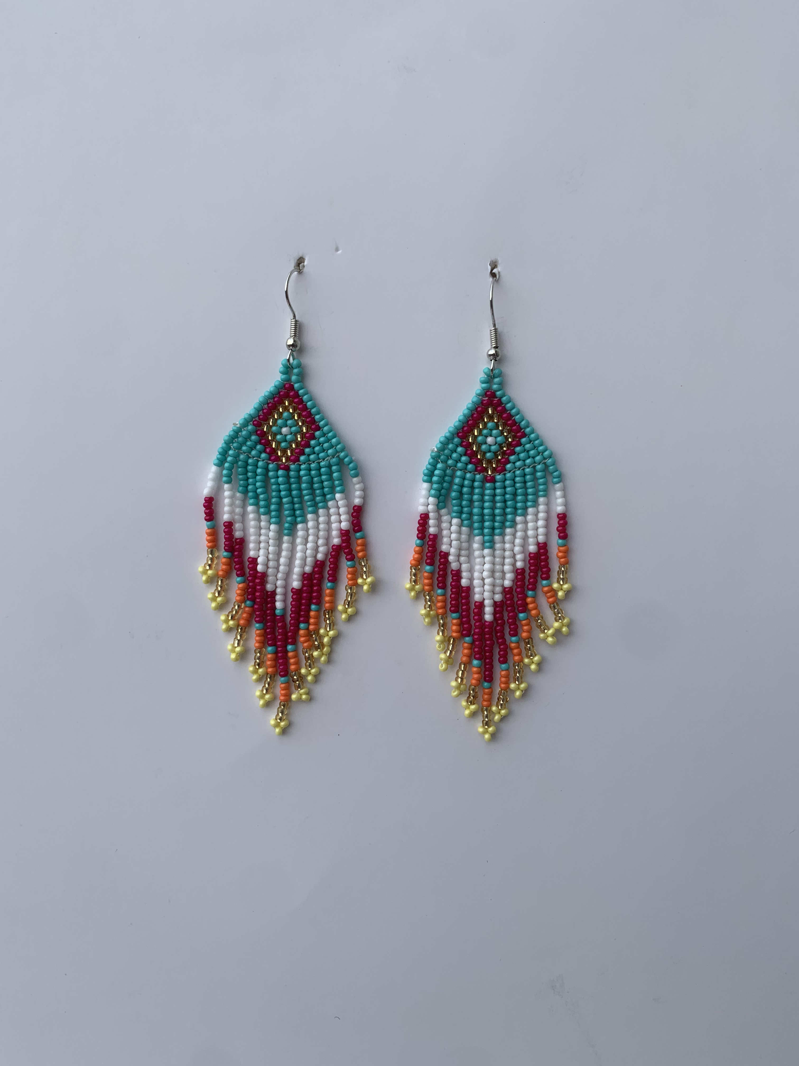 Dadieso Lagoon Feather — handmade teal, red, gold beaded fringe earrings by Rama, Ghana, Duncan BC