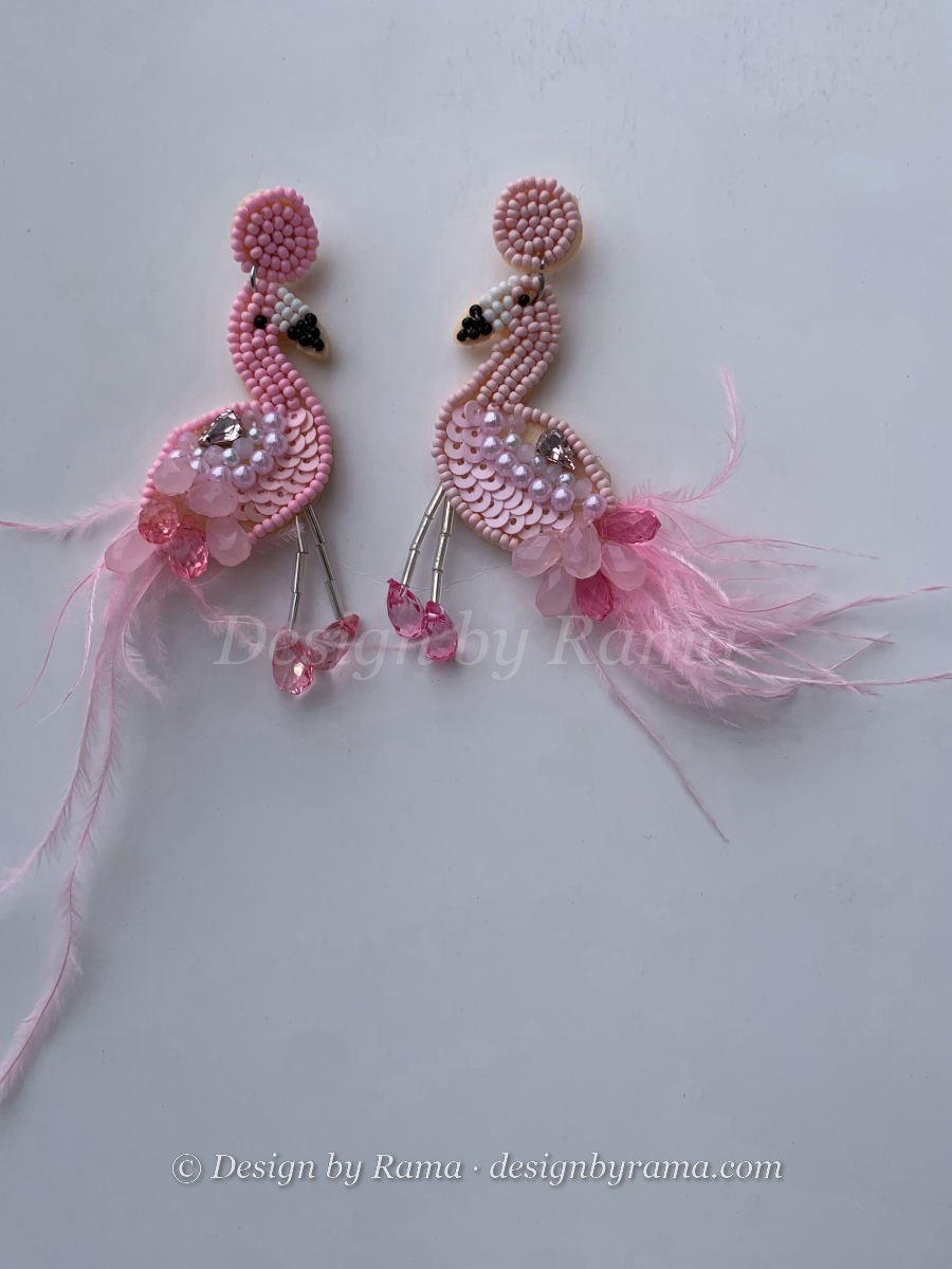 Beaded flamingo earrings in pink and white with sequin body, crystal foot drops, and real feather accent.