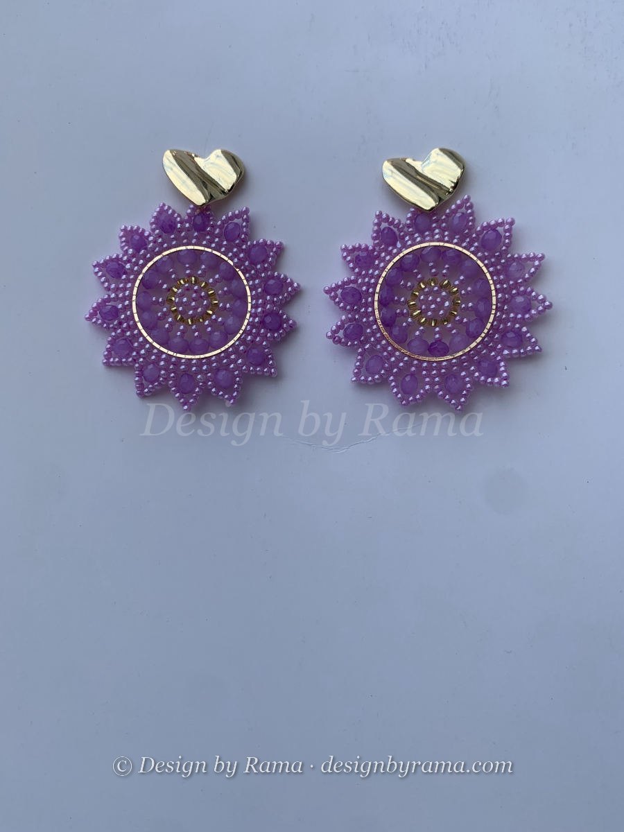 Round lavender mandala disc earrings with faceted crystal accents in soft purple tones and hammered gold heart stud.